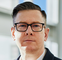 Portrait of Alexander Hughes, executive and chief operating officer of a cryptocurrency trading enterprise
